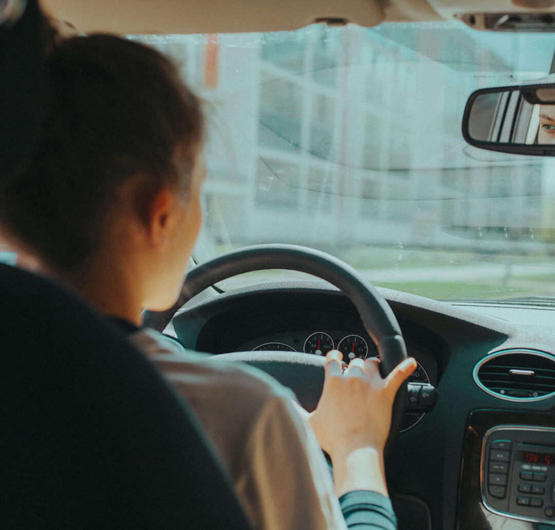 Woman in the driver's seat looking at the road